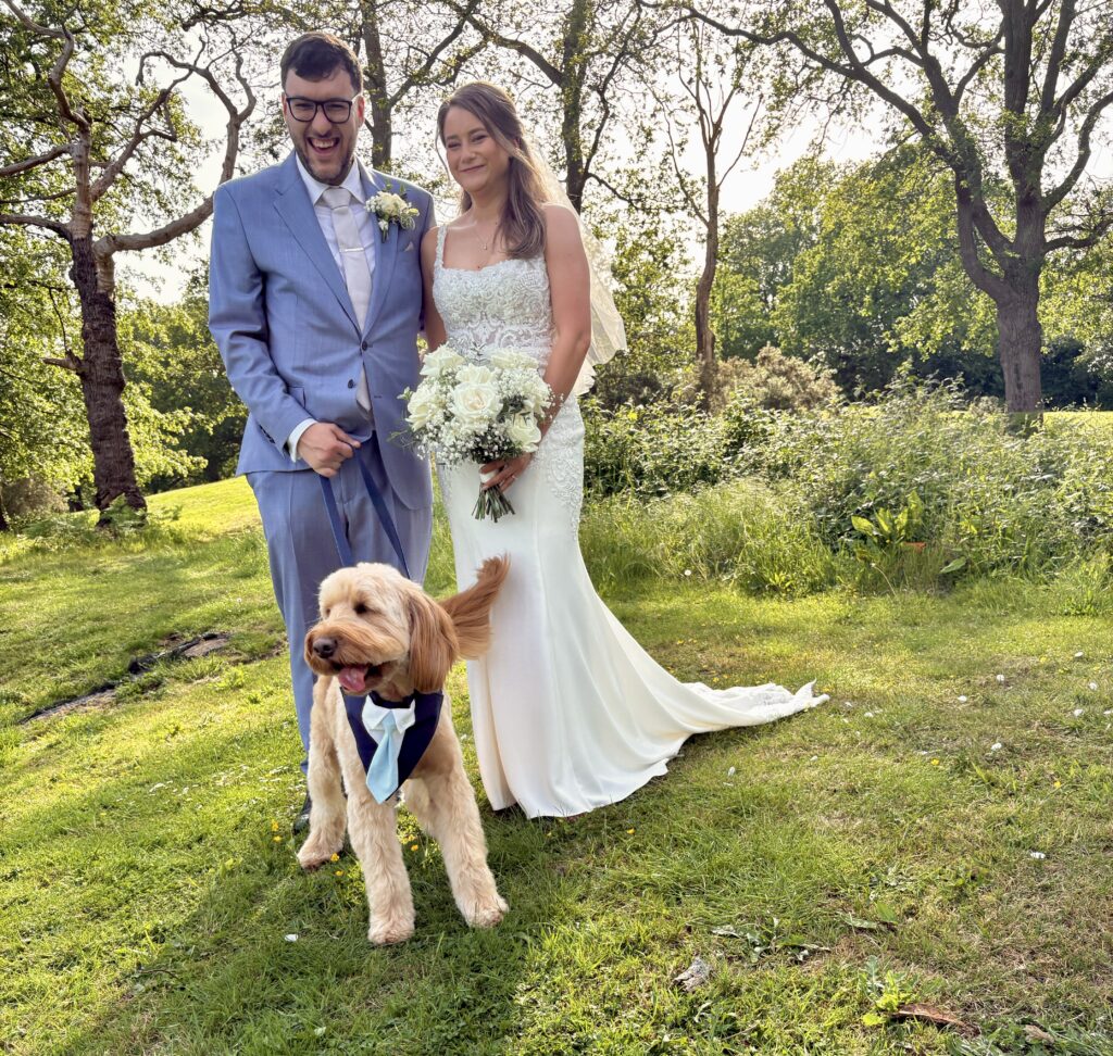 Bride & groom with dog in bow tie